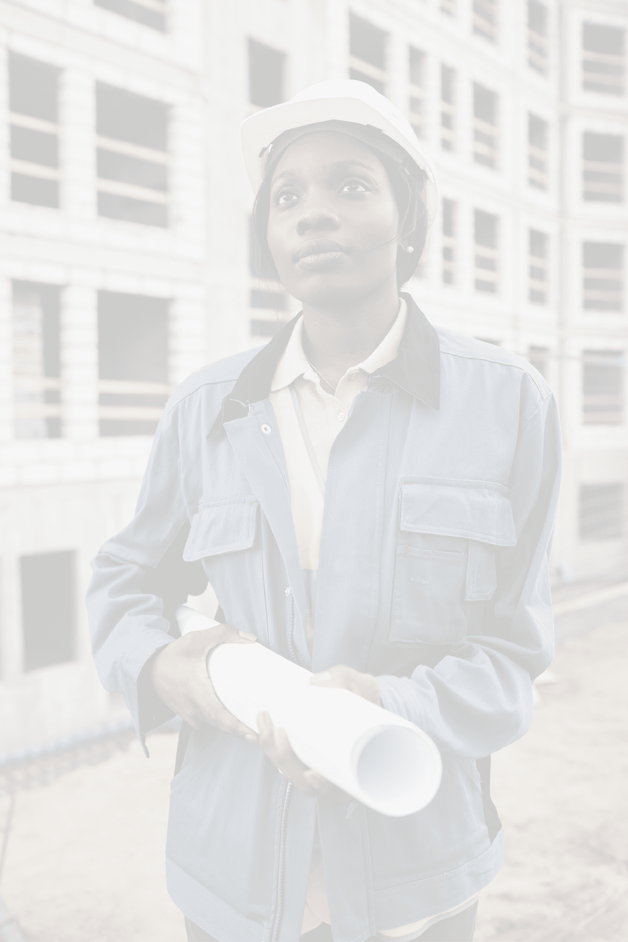Vertical portrait of young female engineer posing at construction site