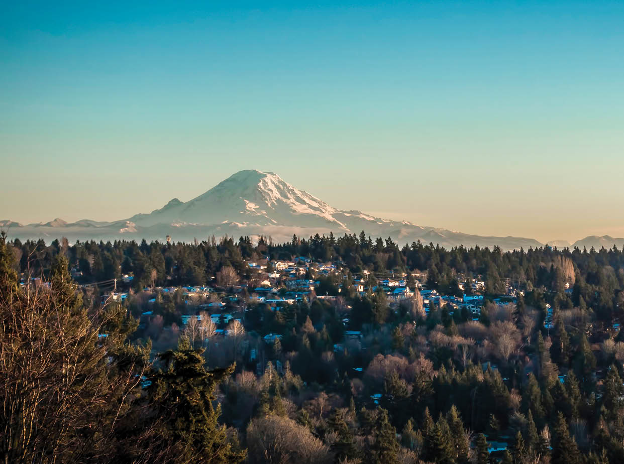 A veiw of Mount Rainier on a clear winter day with homes in the forefround. Shot taken from Burien, Washington.