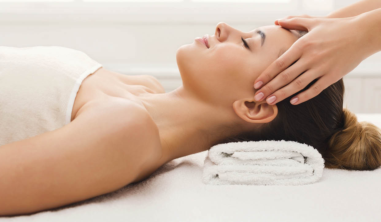 Facial massage. Spa, resort, beauty and health concept. Beautiful woman getting professional face treatment, copy space