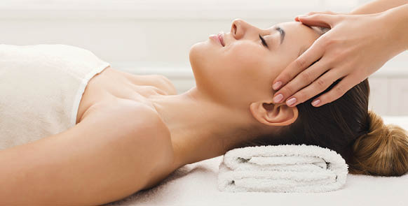 Facial massage. Spa, resort, beauty and health concept. Beautiful woman getting professional face treatment, copy space
