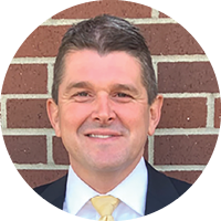 A man wearing a suit and tie. Description generated by AI