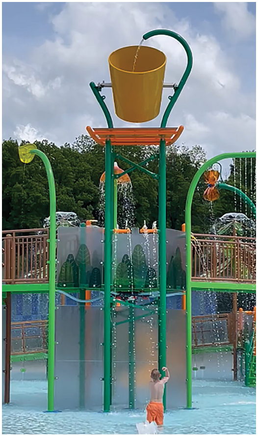 A boy is playing in a water playground. Description generated by AI