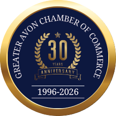 A gold and blue circle with the words “Greater Chamber of Commerce of Avon" written in the center. Description generated by AI