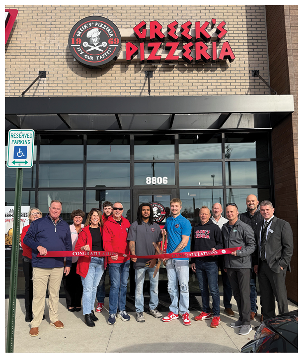 A group of people standing in front of a pizza shop. Description generated by AI