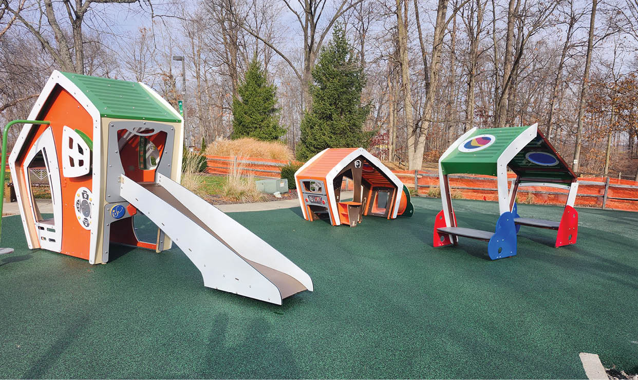 A playground with a slide and a small house. Description generated by AI