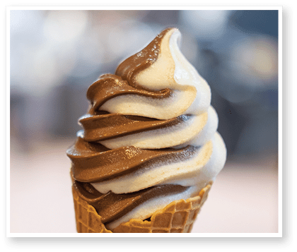 Vanilla and Chocolate Ice cream with waffle cone. blur background.