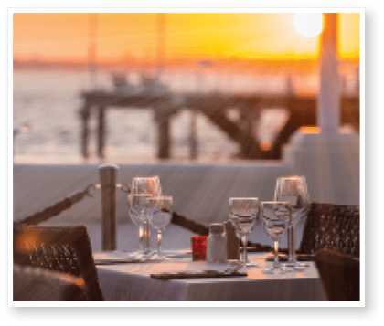 Close-up of outdoor place setting during sunset at waterfront