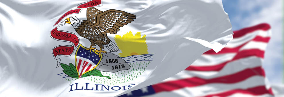 The Illinois state flag waving along with the national flag of the United States of America. In the background there is a clear sky. Illinois is a state in the Midwestern region of the United States