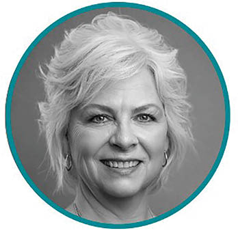 A woman with blonde hair and a blue shirt. Description generated by AI