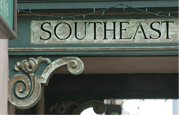 A sign that reads “Southeast" is above a building. AI generated content