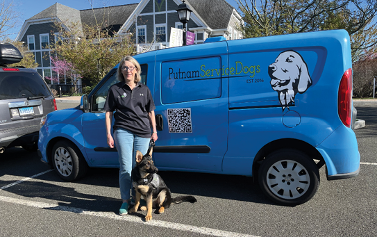 A woman stands next to a blue van with a dog on a leash. The van is a Putt-Putt van. AI generated content
