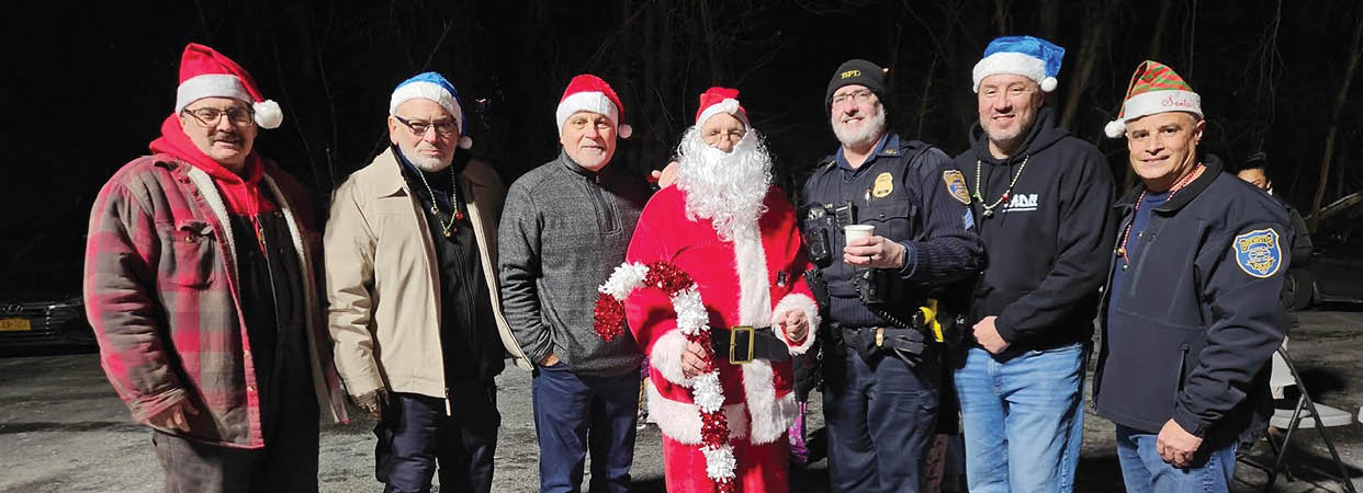 A group of people pose for a photo with a man dressed as Santa Claus. AI generated content