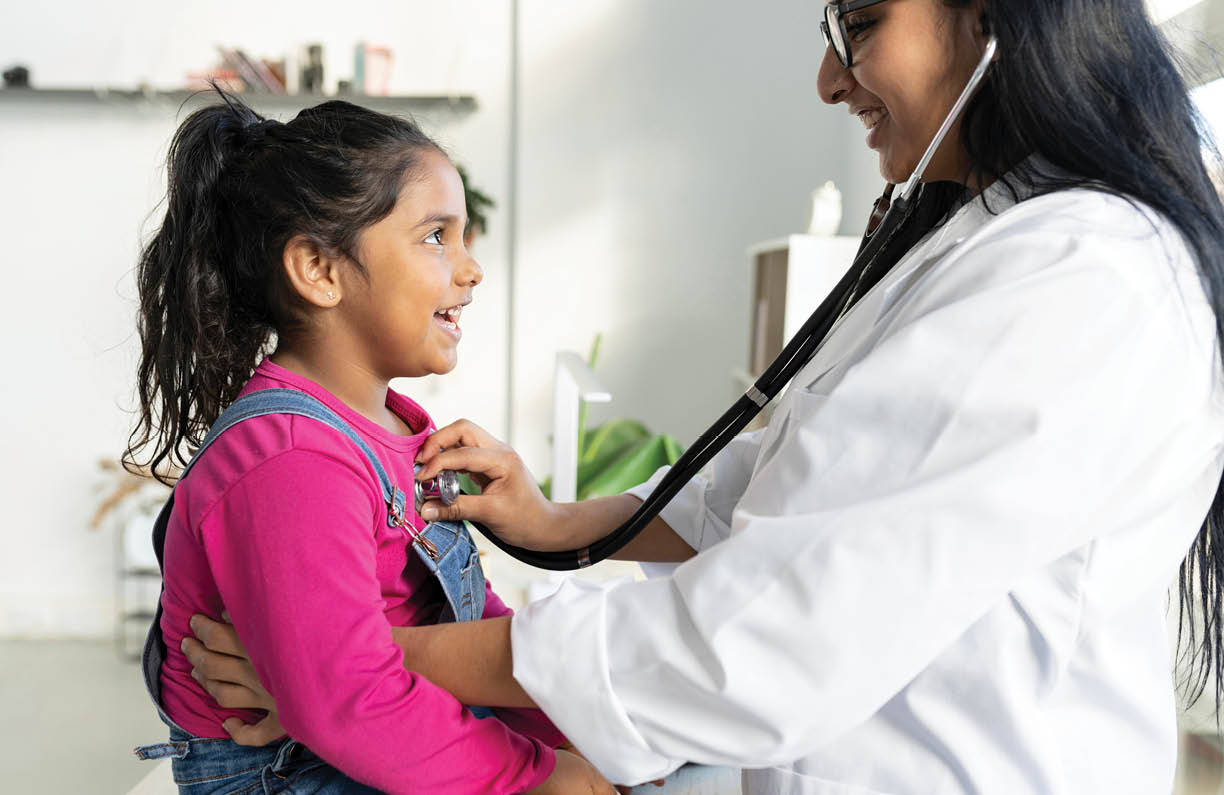 Female doctor with little Hispanic girl, auscultating