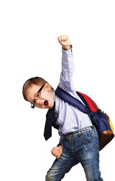 Cheerful smiling little boy with big backpack jumping and having fun against blue wall. Looking at camera. School concept. Back to School