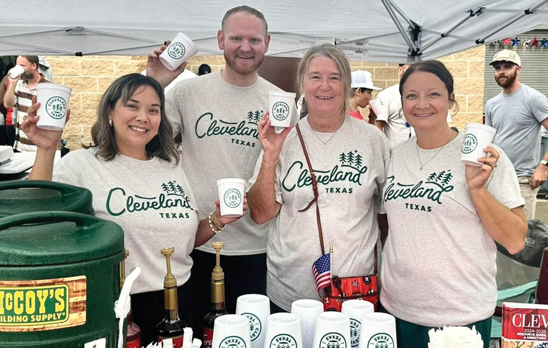 Four people are standing in front of a table with cups and bottles. They are holding up cups and posing for a picture. AI generated content
