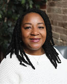 A woman with dreadlocks is smiling for the camera. AI generated content