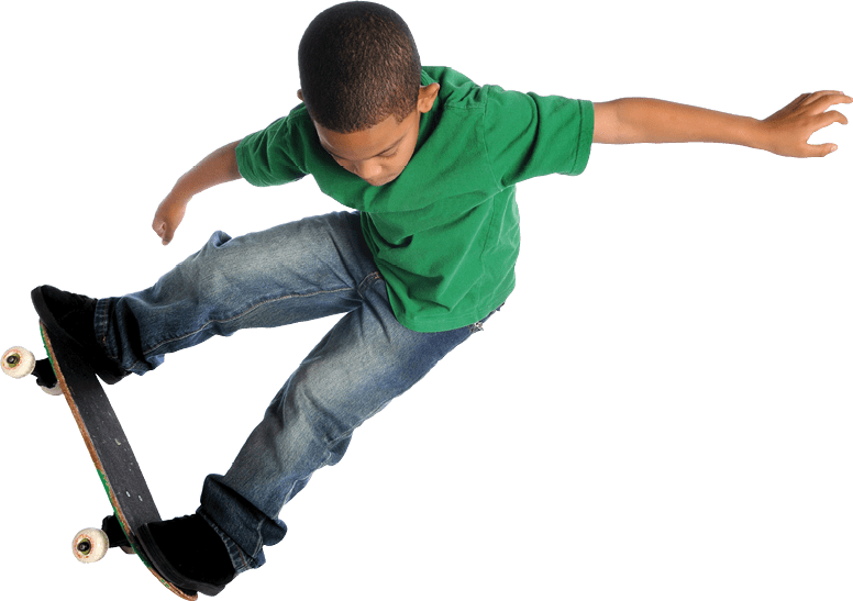 Young African American boy performing trick with skate board isolated over white