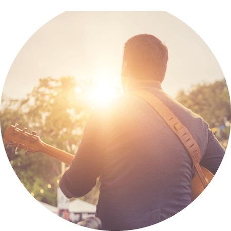Musicians are playing guitar on stage.