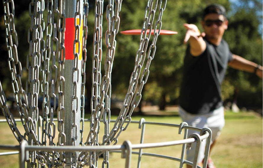Disc golfer shows excellent form and release for ideal putting shot.