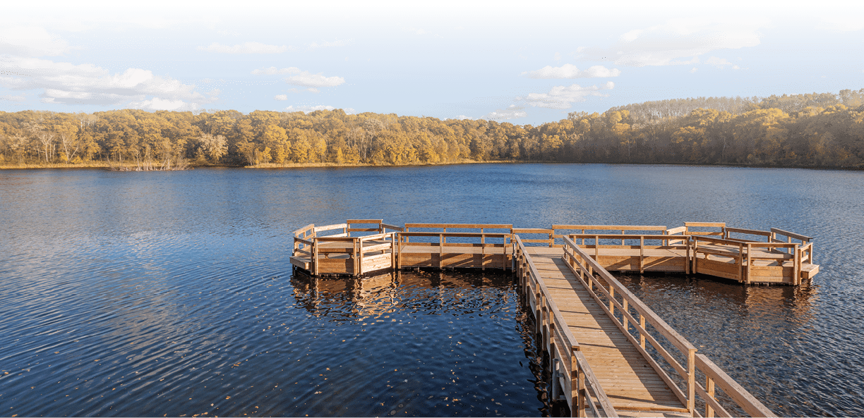 A Wide Angle Shot of the Holland Lake Dock and Landscape in Fall Colors during Golden Hour