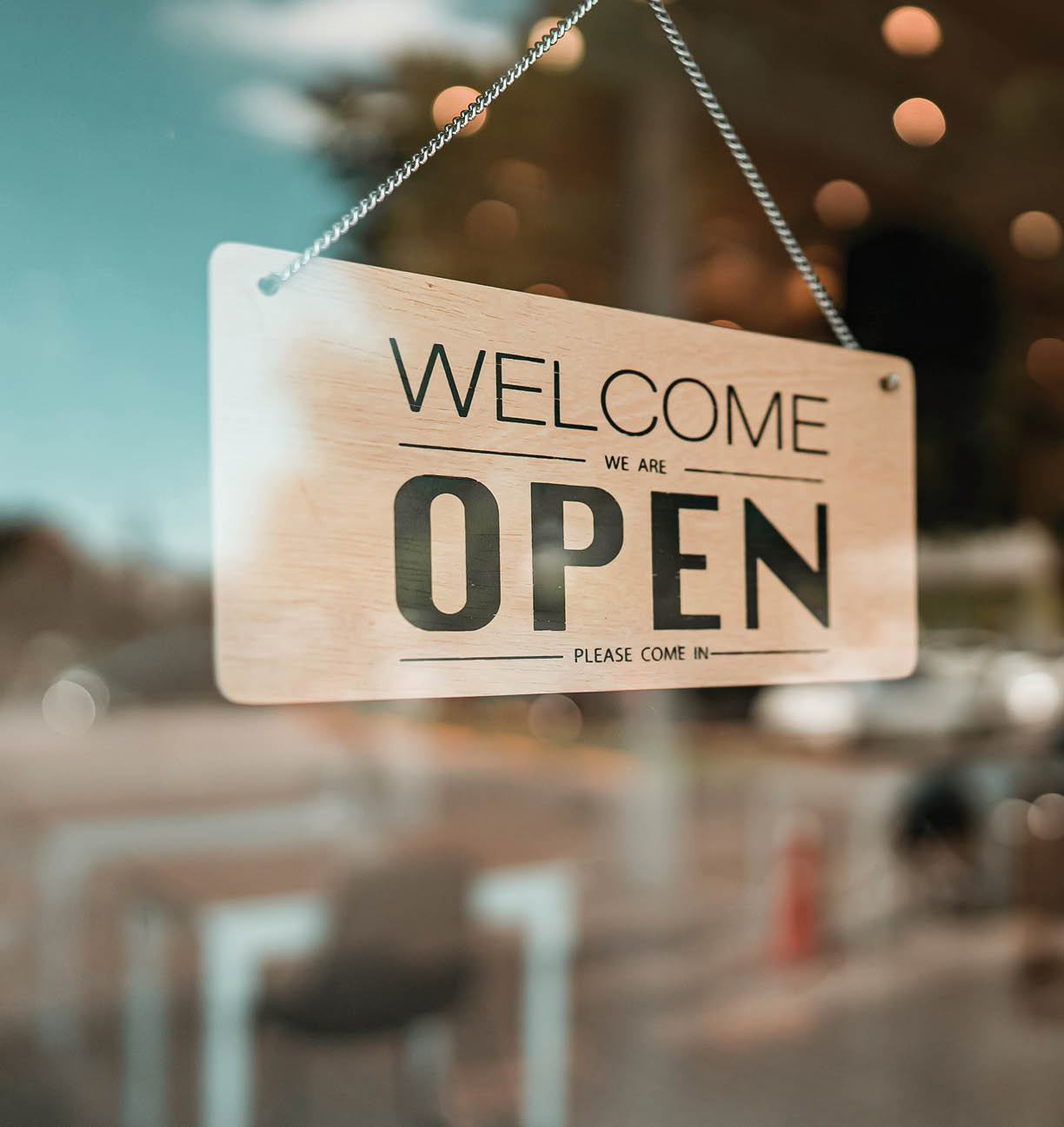 Open cafe or restaurant. Open sign board on glass door in modern cafe coffee shop