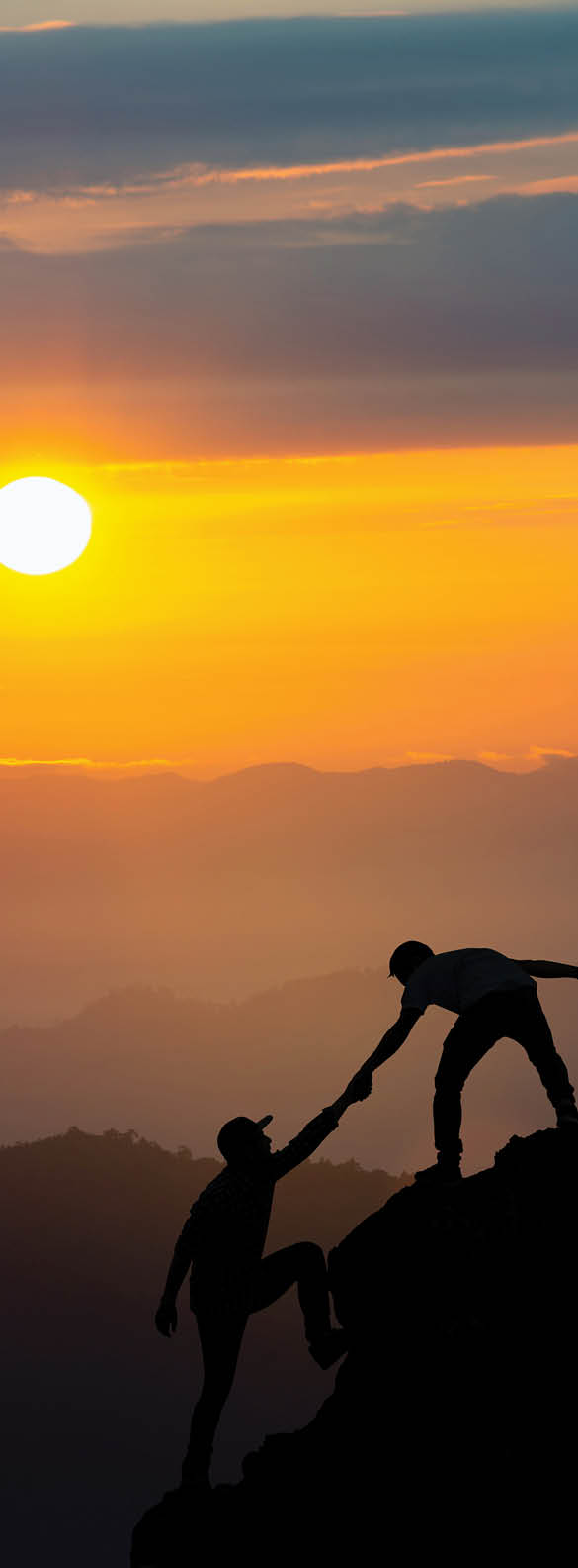 Teamwork friendship hiking help each other trust assistance silhouette in mountains, sunrise. Teamwork of two men hiker helping each other on top of mountain climbing team beautiful sunrise landscape