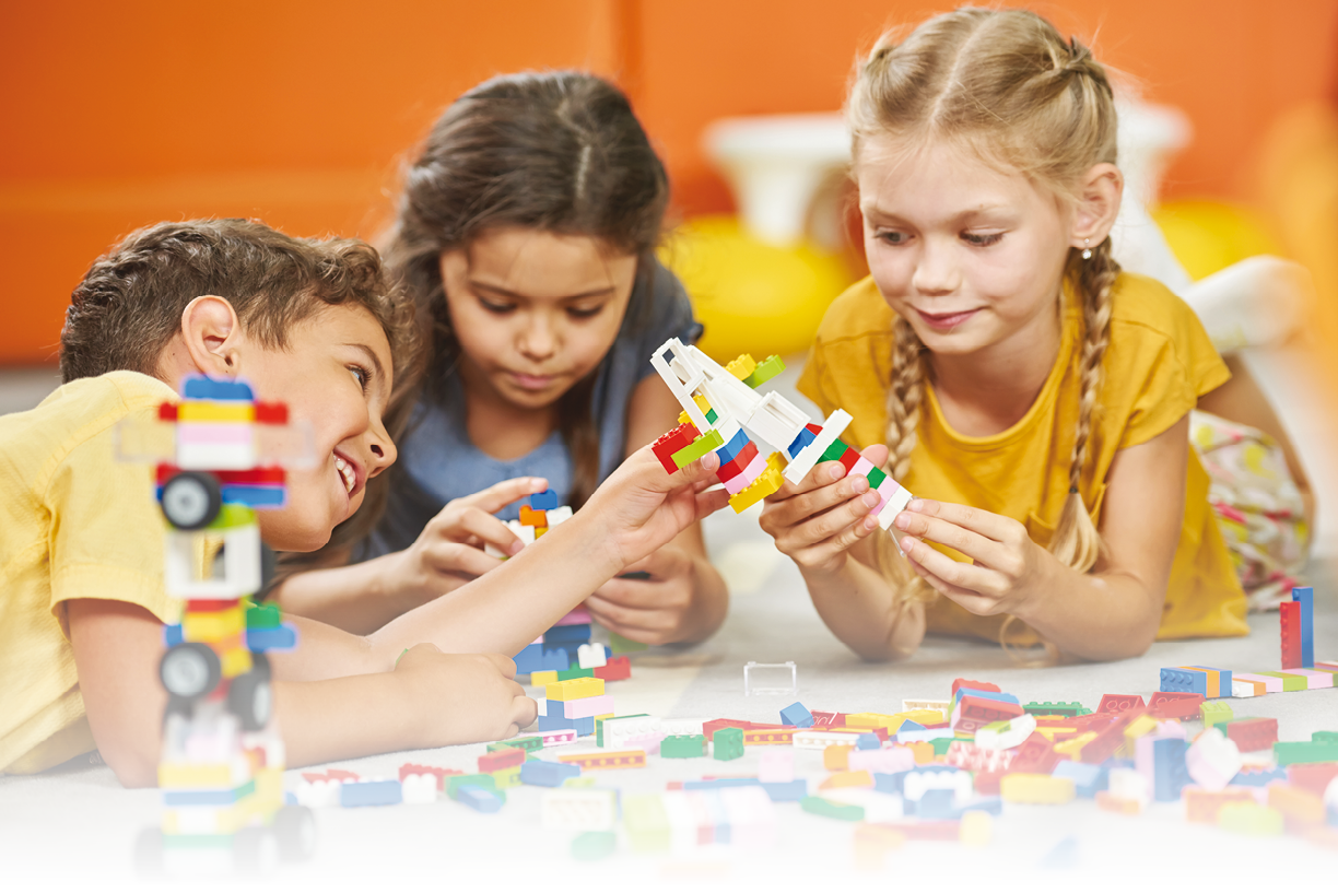 Group of kids playing with plastic blocks  Children playing with constructor  Developing toys for kids 