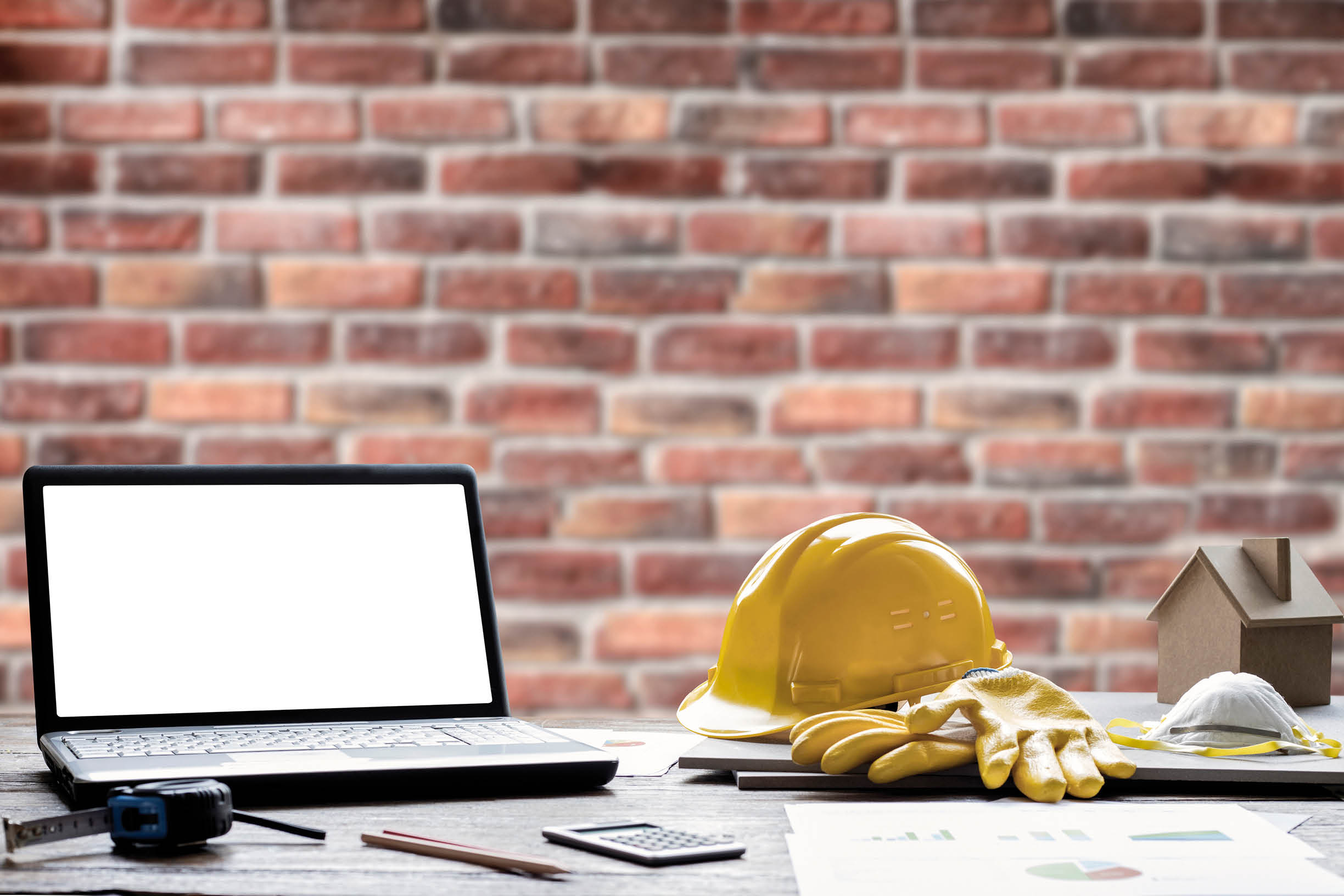 civil engineer helmet and laptop