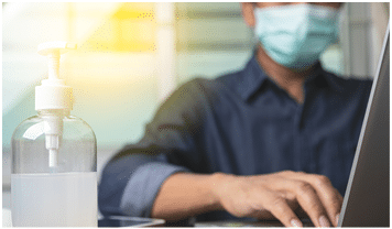 Alcohol gel with male employee wearing a health mask Preventing corona virus infection covid-19 in back, concept of working from home and social distancing 