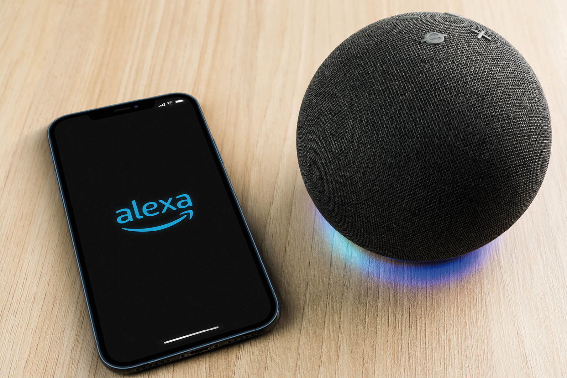 Alexa, Smart speaker and virtual assistant from Amazon company connected to smartphone app  Wooden background  Rio de Janeiro, RJ, Brazil  September 2021 