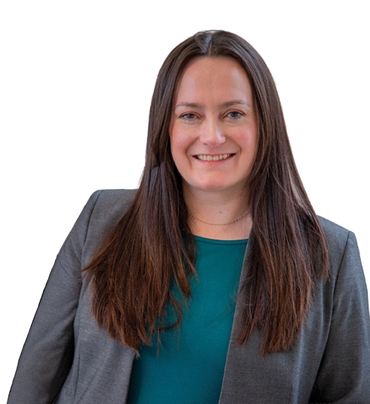 A woman wearing a green shirt and a gray suit is smiling for the camera. AI generated content