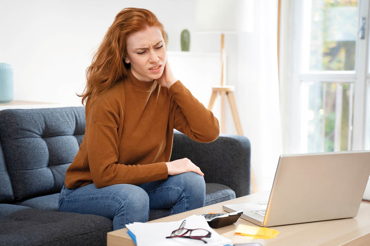 One young redhead woman suffers neck pain cramp