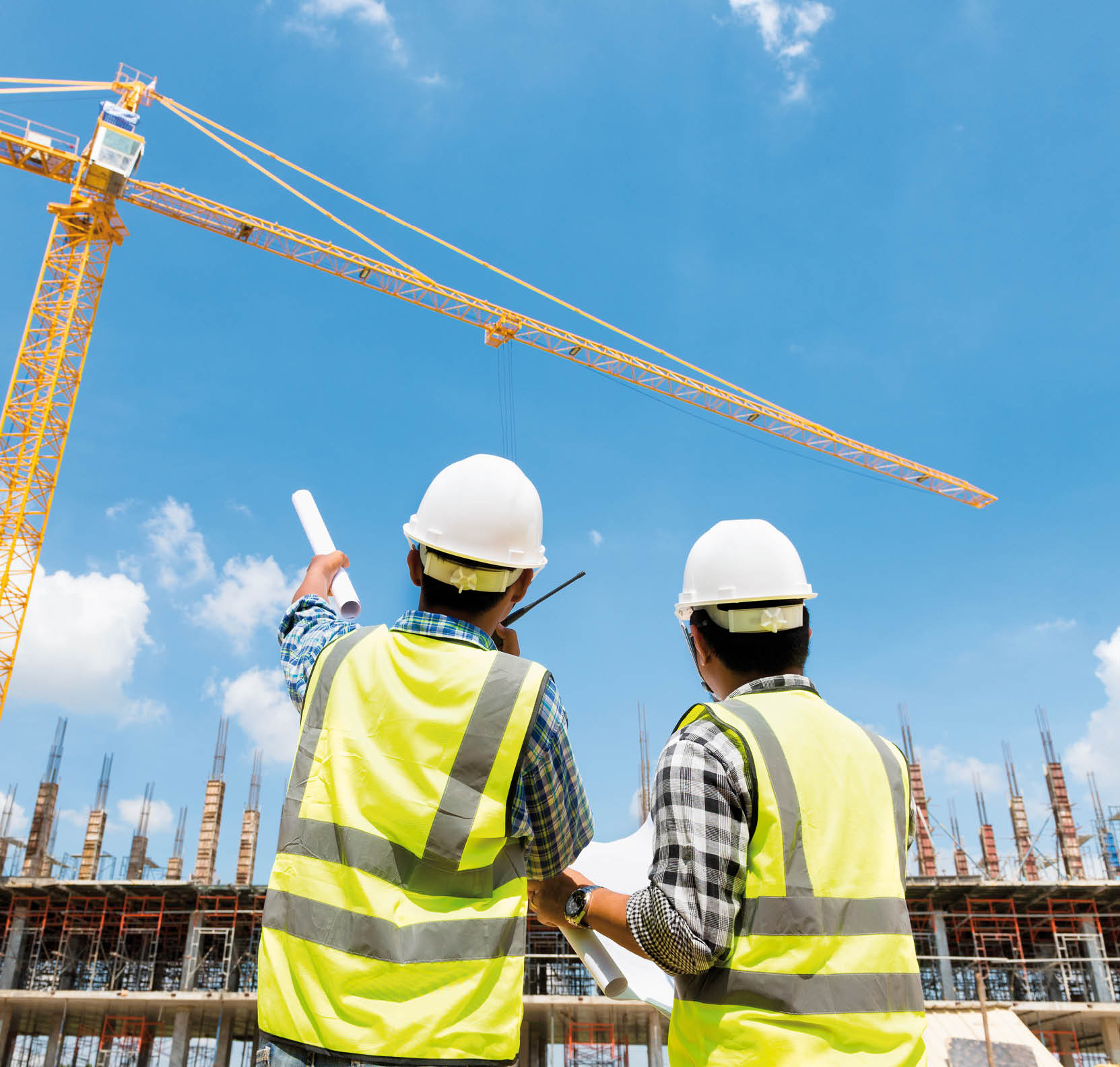 Civil engineer checking work with walkie-talkie for control and management in the construction site or building site of highrise building