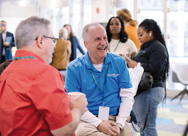 A man in a blue shirt is smiling. Description generated by AI