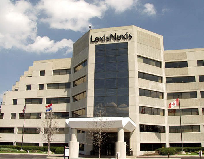 A large white building with a blue sign that says “lexis nexis". Description generated by AI