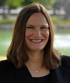 A woman with a smile on her face. Description generated by AI