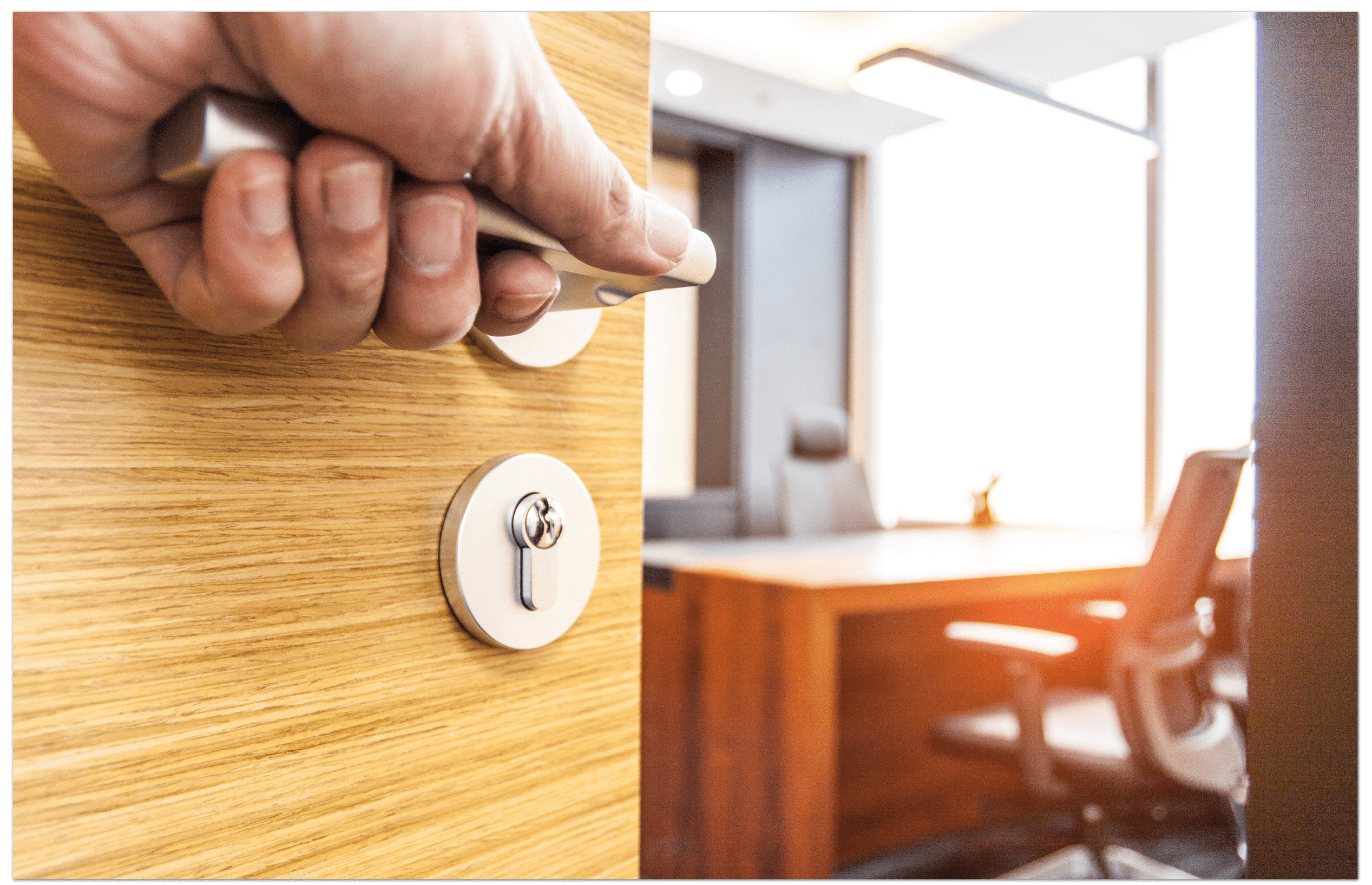 Hand pushing open the wooden door of the office