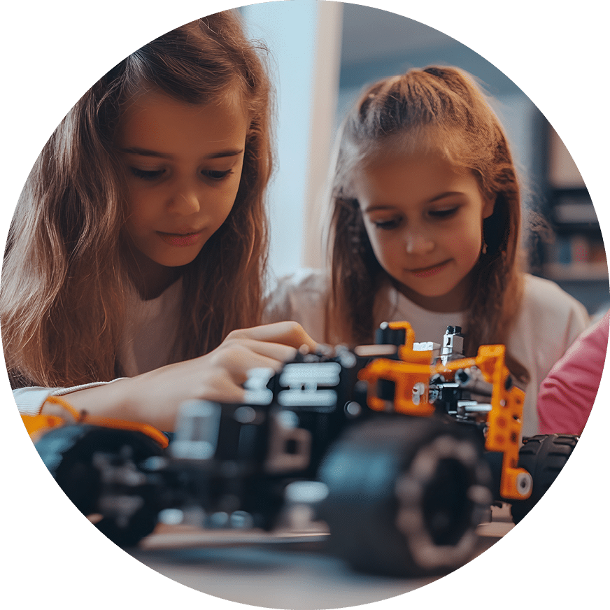 Girls Exploring Robotics and Engineering in After School STEM Club Children Learning Coding Programming and Building Robots in Elementary School Classroom