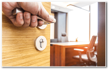 Hand pushing open the wooden door of the office