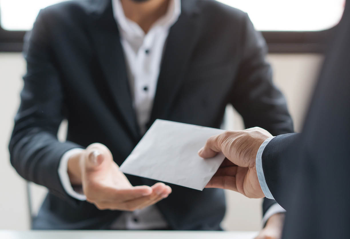 Close up view of office worker receiving salary from boss.