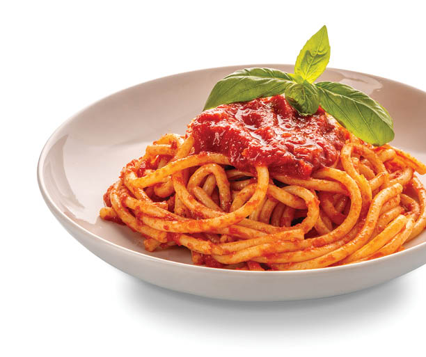 Bucatini pasta with tomato sauce and basil leaves in white plate isolated with clipping Path included
