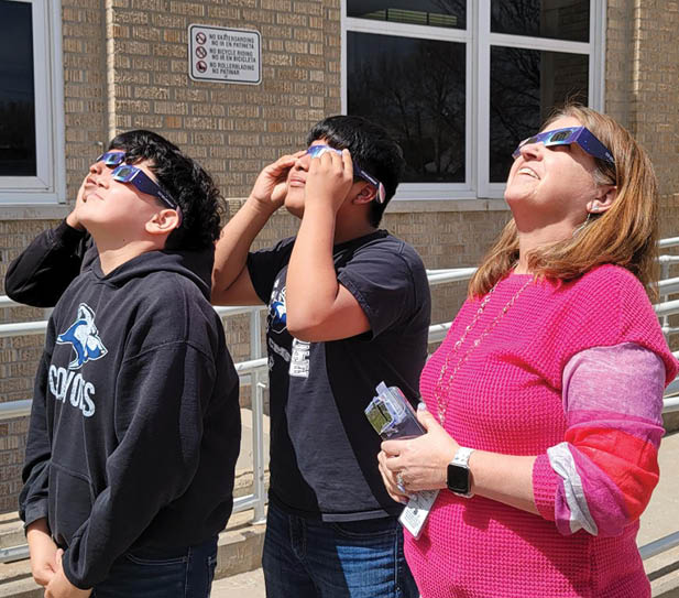 Three people wearing glasses and looking up at the sky. AI generated content