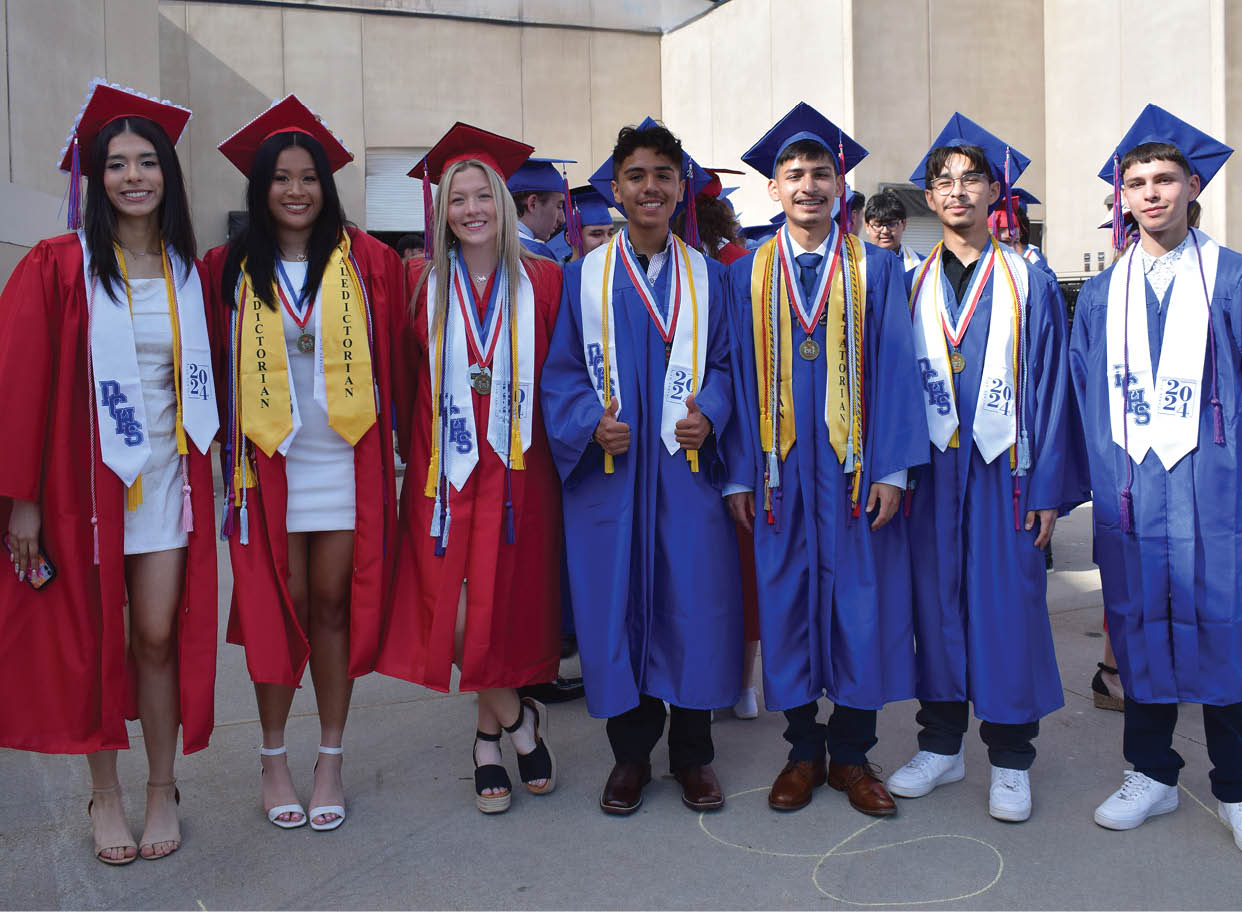 A group of people wearing graduation caps and gowns pose for a photo. AI generated content
