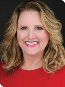 A woman with blonde hair and a red shirt is smiling for the camera. AI generated content