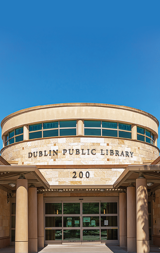 The entrance to the Dublin Public Library features a pair of large white statues on either side of the doorway. AI generated content