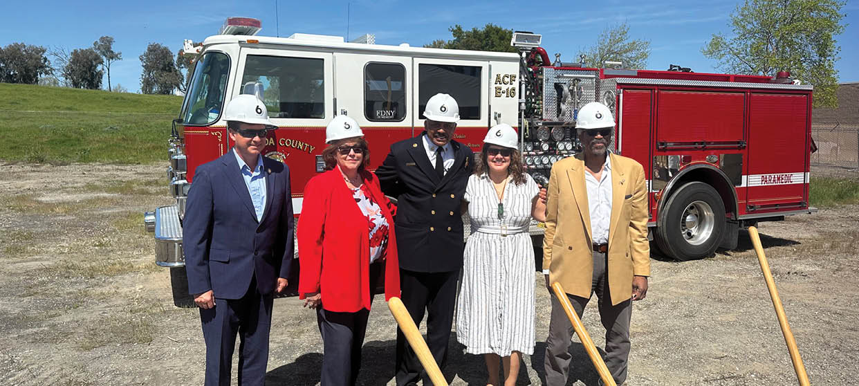 A group of people pose in front of a fire truck. AI generated content