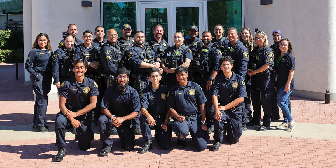A group of police officers pose in front of a police station. AI generated content