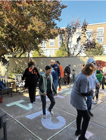 A group of people are playing a game on a sidewalk. AI generated content