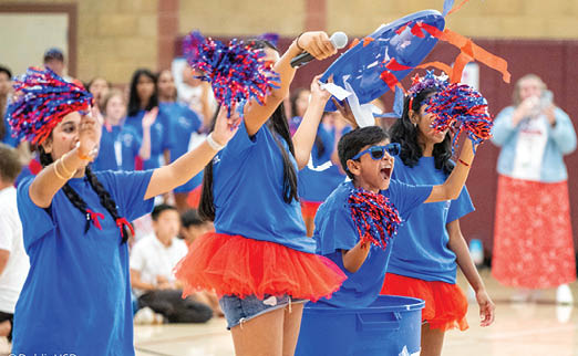 A group of cheerleaders wearing blue shirts and holding pom poms. AI generated content