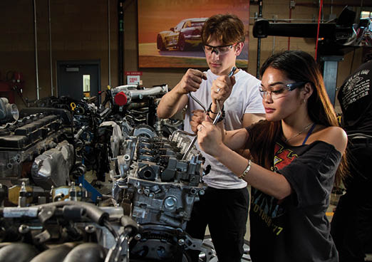 Two people working on a car engine in a garage. AI generated content